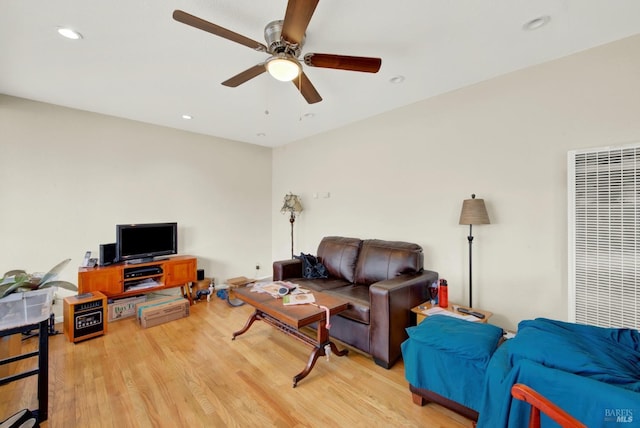 living area with recessed lighting, a ceiling fan, and light wood finished floors