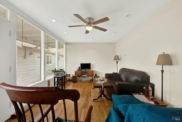 living area with a ceiling fan, recessed lighting, and wood finished floors