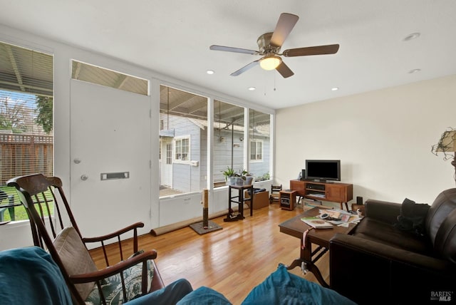 living room featuring recessed lighting, light wood-style flooring, and a ceiling fan