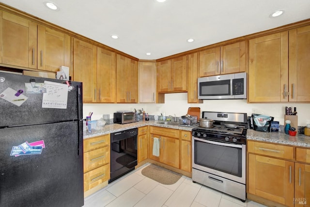 kitchen featuring brown cabinetry, recessed lighting, black appliances, and light stone countertops