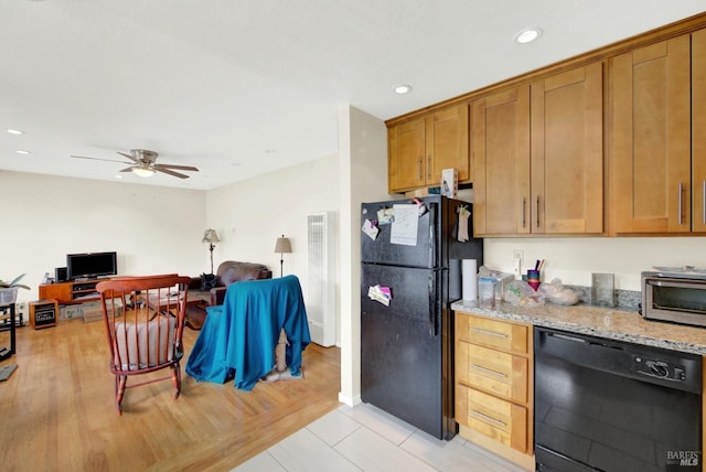 kitchen featuring black appliances, recessed lighting, light stone countertops, and brown cabinets