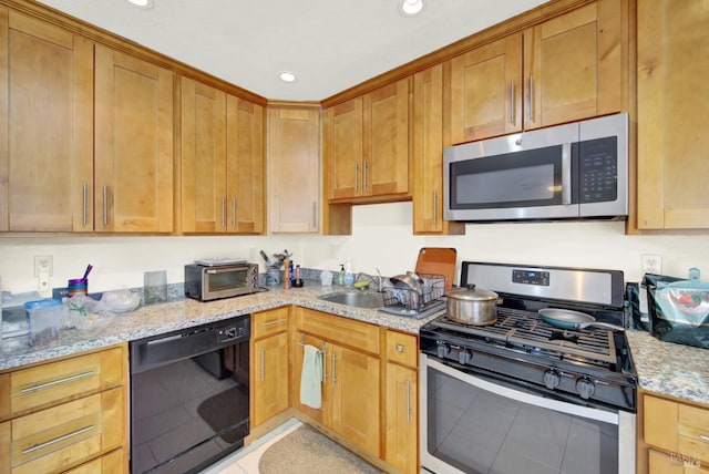 kitchen featuring light stone counters, recessed lighting, stainless steel appliances, and a sink