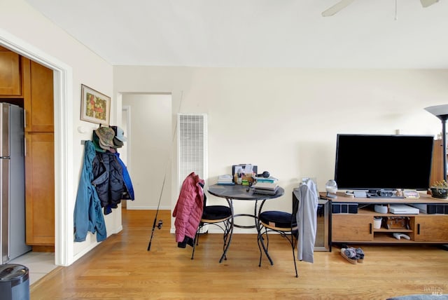 dining space featuring visible vents, a ceiling fan, and light wood-style floors