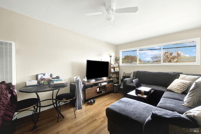 living area featuring light wood-type flooring and ceiling fan