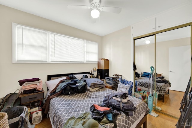 bedroom with a closet, ceiling fan, and light wood-style floors