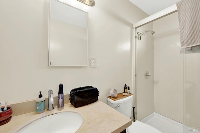 bathroom featuring vanity, toilet, and a stall shower