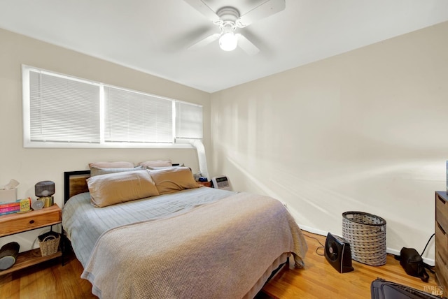 bedroom with wood finished floors and a ceiling fan