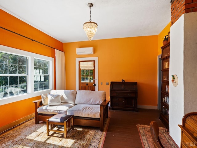 living area with a wall mounted air conditioner, a chandelier, baseboards, and dark wood-style floors