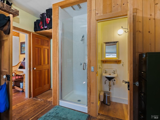 full bath featuring a stall shower and hardwood / wood-style floors