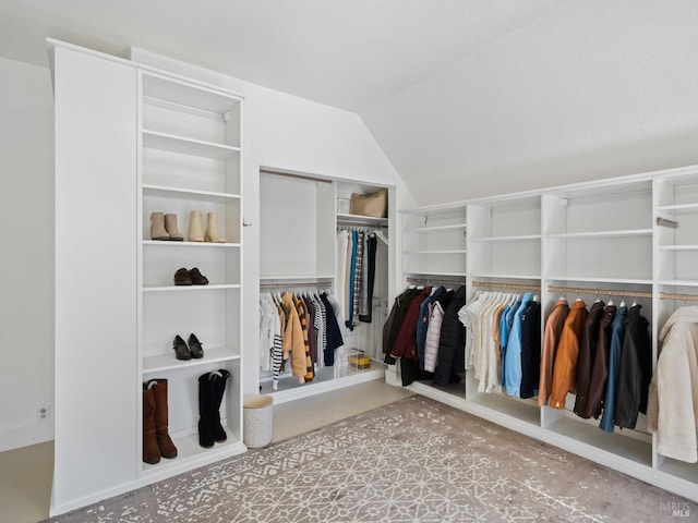 walk in closet with lofted ceiling