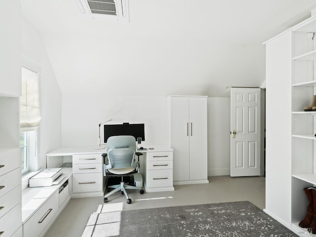 office space with visible vents, lofted ceiling, and concrete flooring