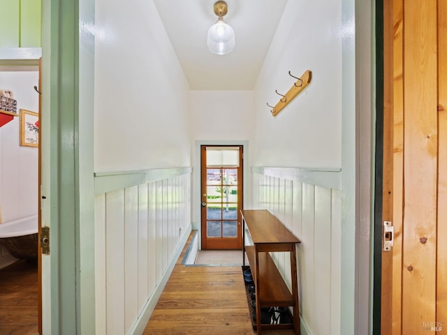 corridor with wainscoting and wood finished floors