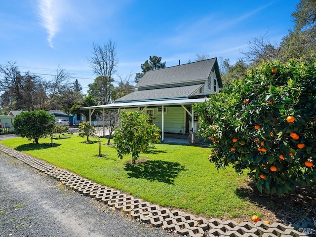 view of front facade featuring a porch, a front lawn, and a shingled roof