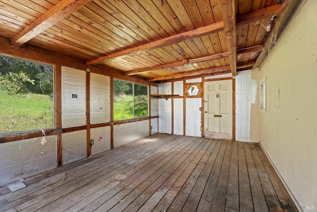 unfurnished sunroom with beam ceiling and wood ceiling