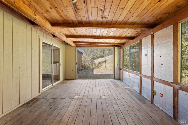 unfurnished sunroom featuring beamed ceiling and wooden ceiling