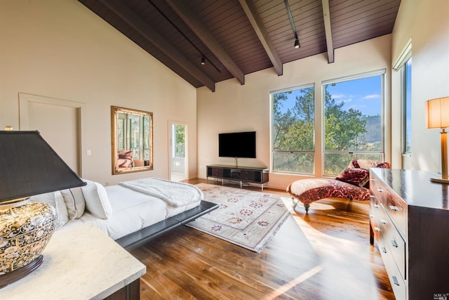 bedroom with wood ceiling, beamed ceiling, wood finished floors, and high vaulted ceiling