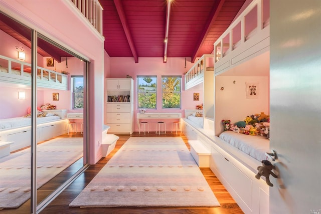 interior space featuring wood ceiling, beamed ceiling, wood finished floors, and a closet