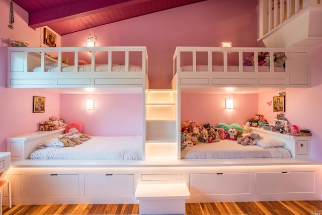 bedroom with wooden ceiling, lofted ceiling with beams, and wood finished floors