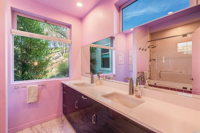 full bathroom featuring a sink, baseboards, marble finish floor, and double vanity