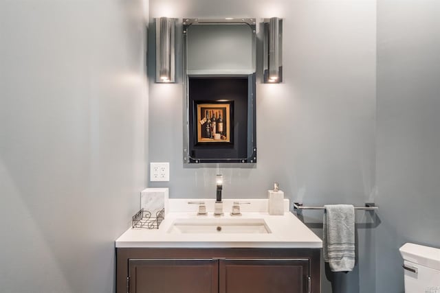 half bath featuring toilet and vanity