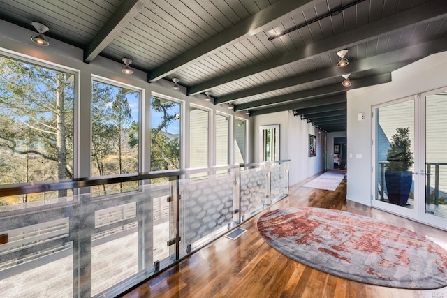 sunroom / solarium featuring beamed ceiling, visible vents, and wooden ceiling