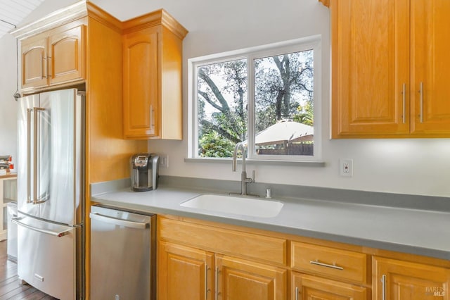 kitchen featuring a sink, appliances with stainless steel finishes, and light countertops