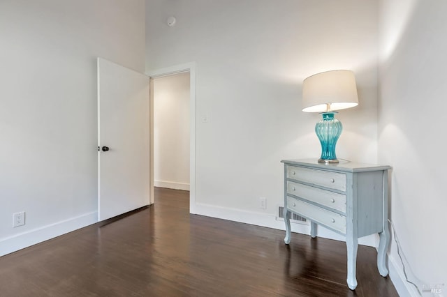 bedroom with visible vents, baseboards, and wood finished floors