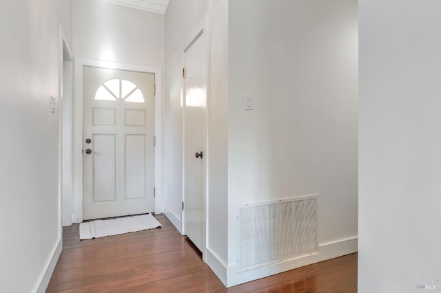 foyer entrance with visible vents, baseboards, and wood finished floors