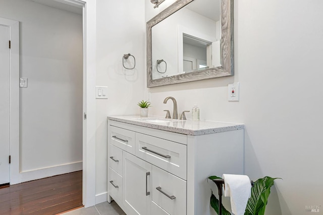 bathroom with wood finished floors and vanity