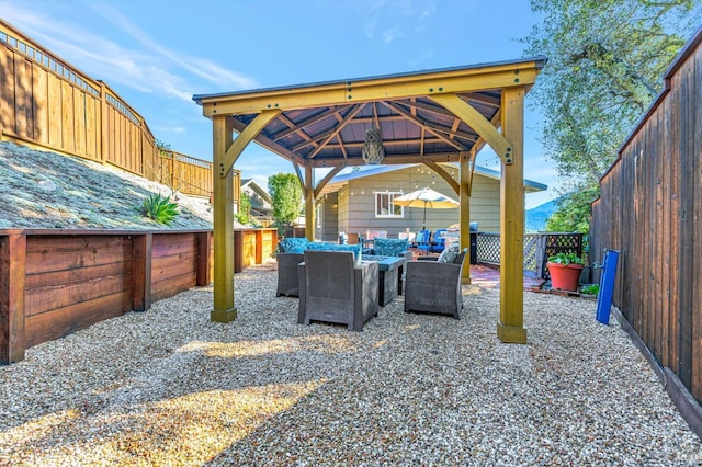 view of patio / terrace with a gazebo, an outdoor hangout area, and a fenced backyard