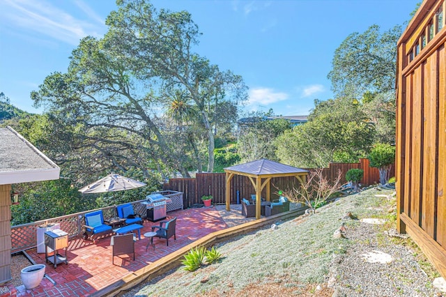 view of patio with an outdoor living space, a gazebo, and a fenced backyard