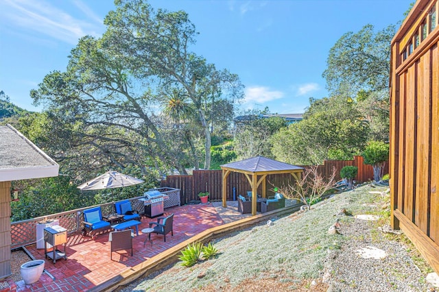 view of yard with a gazebo, a fenced backyard, an outdoor living space, and a patio