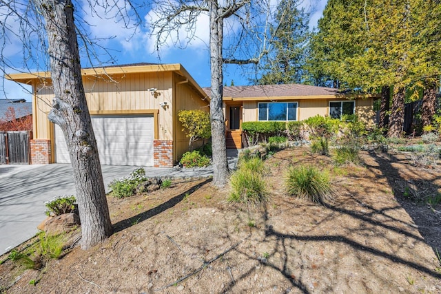 ranch-style home with brick siding, an attached garage, and driveway