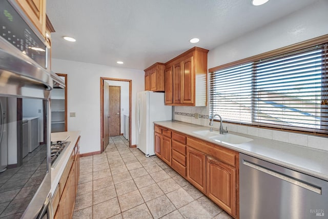 kitchen featuring a sink, recessed lighting, appliances with stainless steel finishes, light countertops, and decorative backsplash