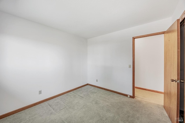 carpeted empty room with baseboards