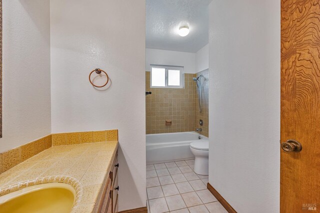 full bathroom with vanity, a textured ceiling, tile patterned floors, toilet, and shower / bathtub combination