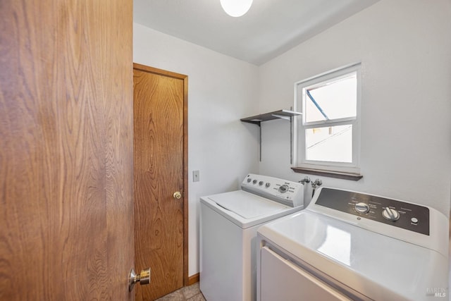 laundry area with laundry area, baseboards, and separate washer and dryer