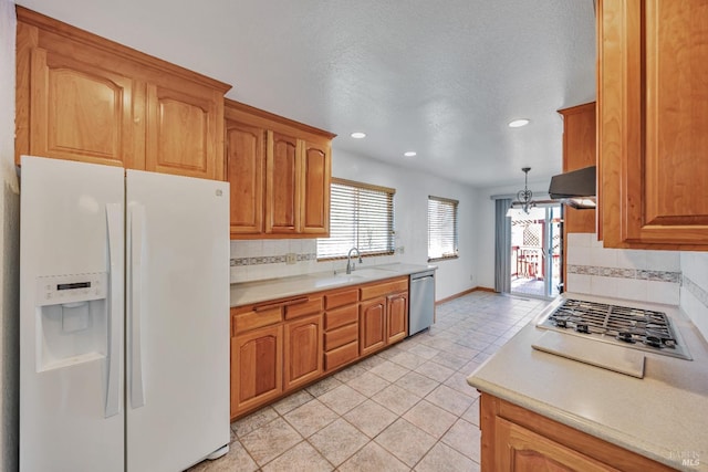 kitchen with extractor fan, light countertops, appliances with stainless steel finishes, and a sink