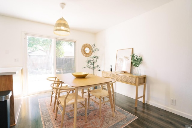 dining space with dark wood-style floors and baseboards