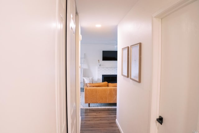 hall with dark wood-type flooring and baseboards