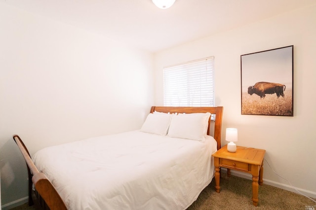 carpeted bedroom featuring baseboards