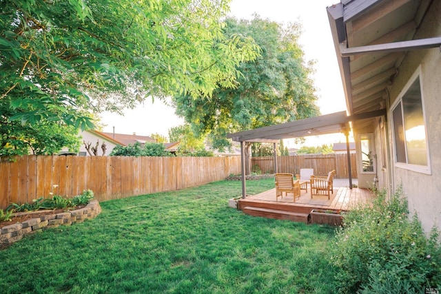 view of yard with a deck and a fenced backyard