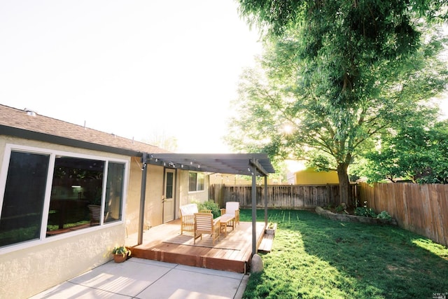 rear view of property with stucco siding, a yard, a fenced backyard, and a pergola