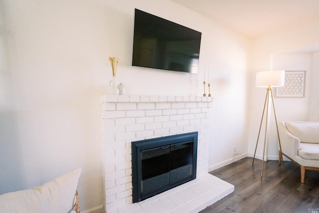 interior details featuring baseboards, wood finished floors, and a fireplace