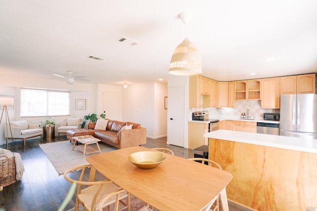 dining space featuring ceiling fan, baseboards, wood finished floors, and visible vents