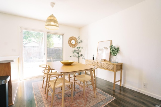 dining room featuring baseboards and dark wood-style floors