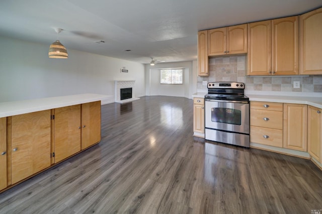 kitchen with tasteful backsplash, stainless steel range with electric stovetop, dark wood finished floors, and a fireplace