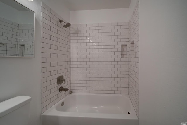 bathroom featuring toilet and washtub / shower combination