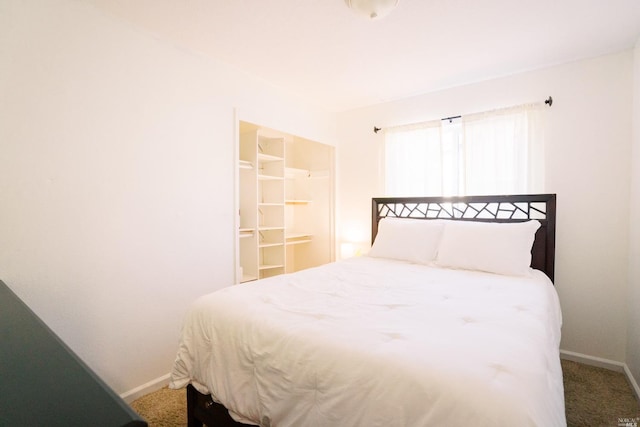 bedroom featuring carpet floors and baseboards