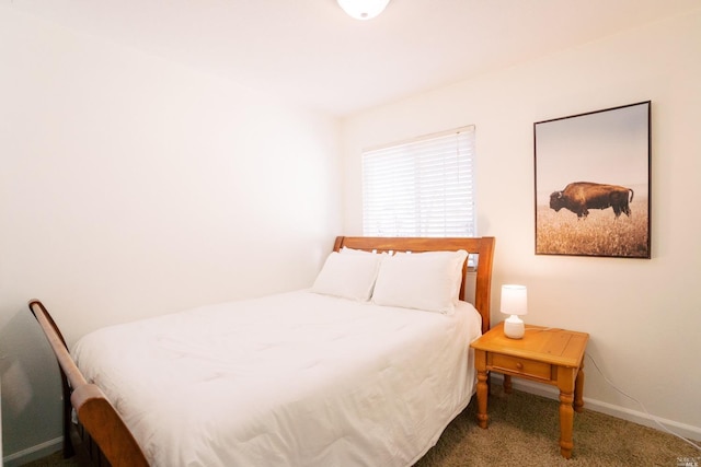 carpeted bedroom with baseboards